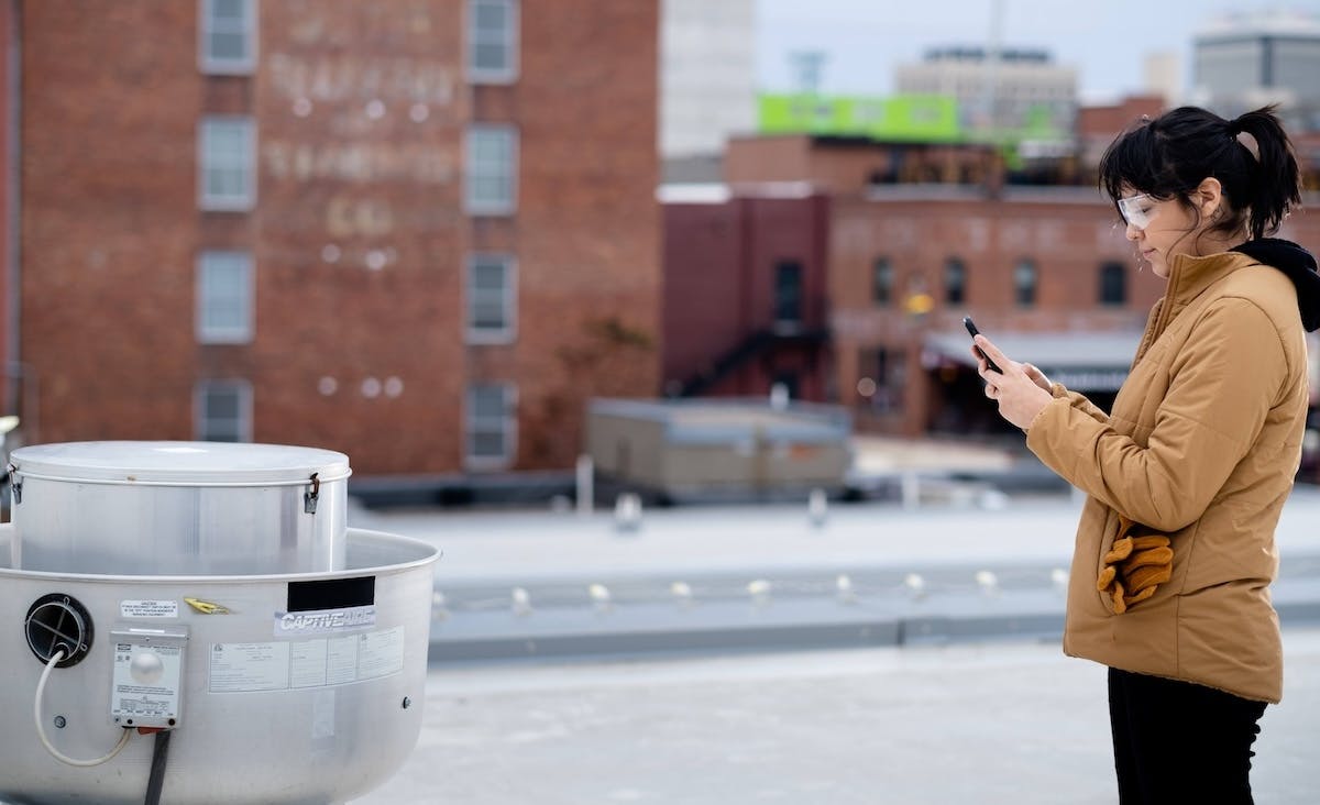 Woman inspecting job site and taking notes.