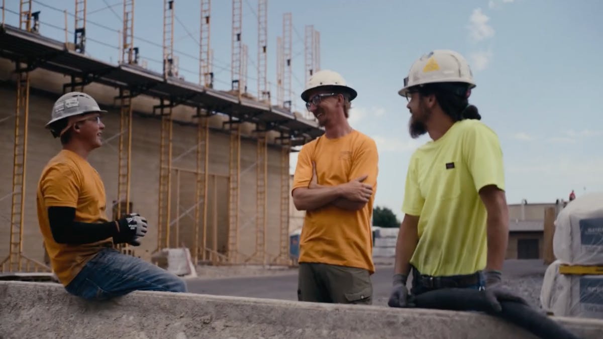 Crew discusses construction progress on active job site.