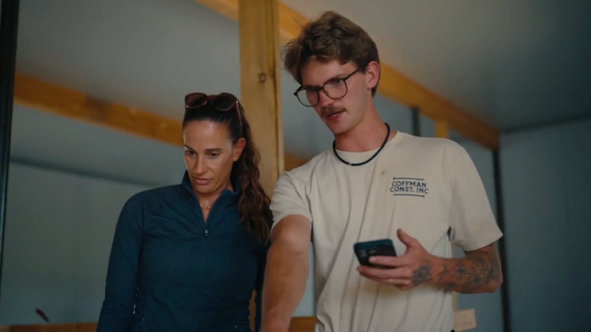 Crew member explaining jobsite details to a supervisor.