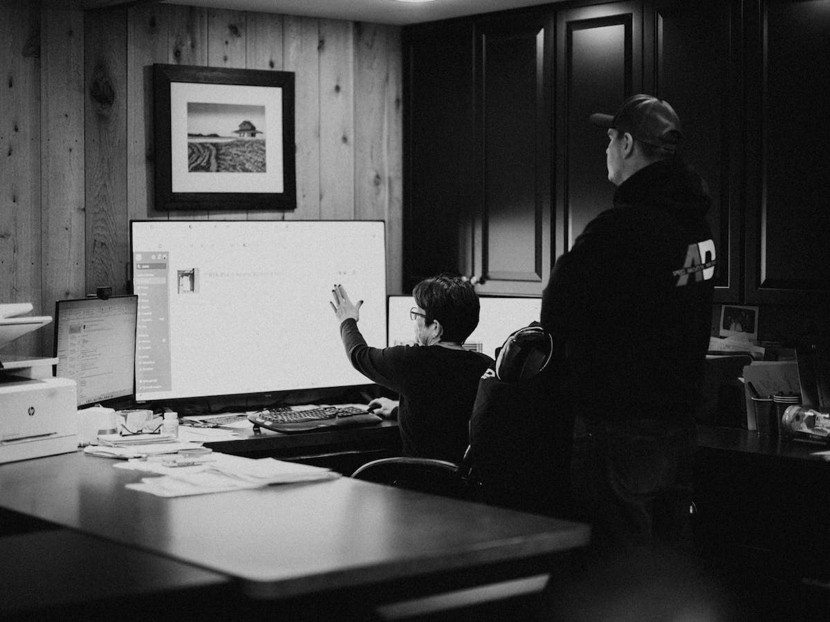 Operations manager reviewing multiple project dashboards